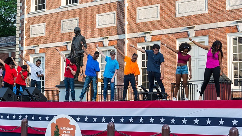 Students perform on stage at Wawa Welcome America