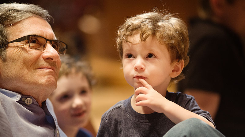 young boy and man listening to the organ demonstration