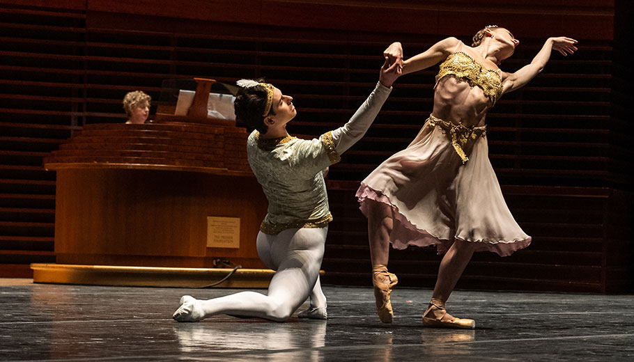 ballet dancers dance on stage while a woman plays the organ at the Kimmel Center