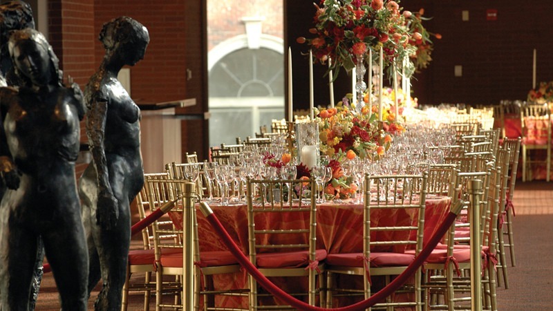 Statues and elaborate dining tables set the ambiance for a sophisticated event.