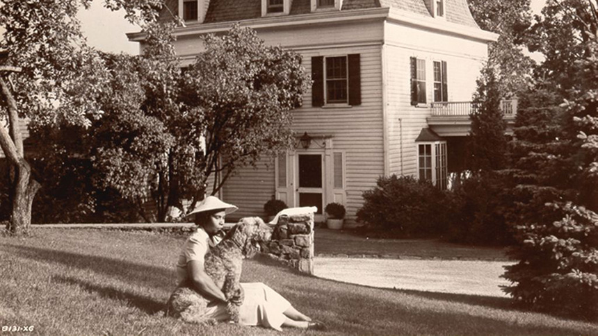 Marian Anderson sits on the lawn with her dog at her home in Danbury, Connecticut | April, 1949
