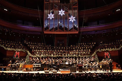 A Gathering of Choirs performing on stage in Verizon Hall decorated with holiday decorations