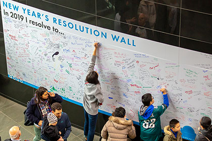 GUests write on the New Years Resolution wall inside the Kimmel Center on New Years Day