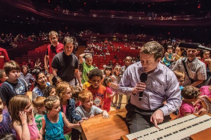 The organ is demonstrated to a large group of children