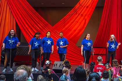 Youth perform Hamilton songs on stage
