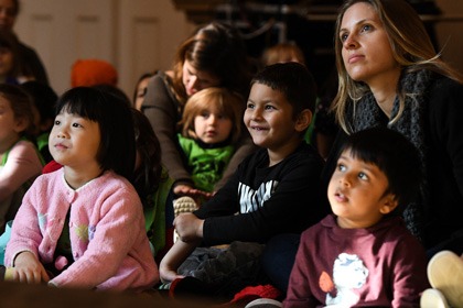children and parents watching a performance