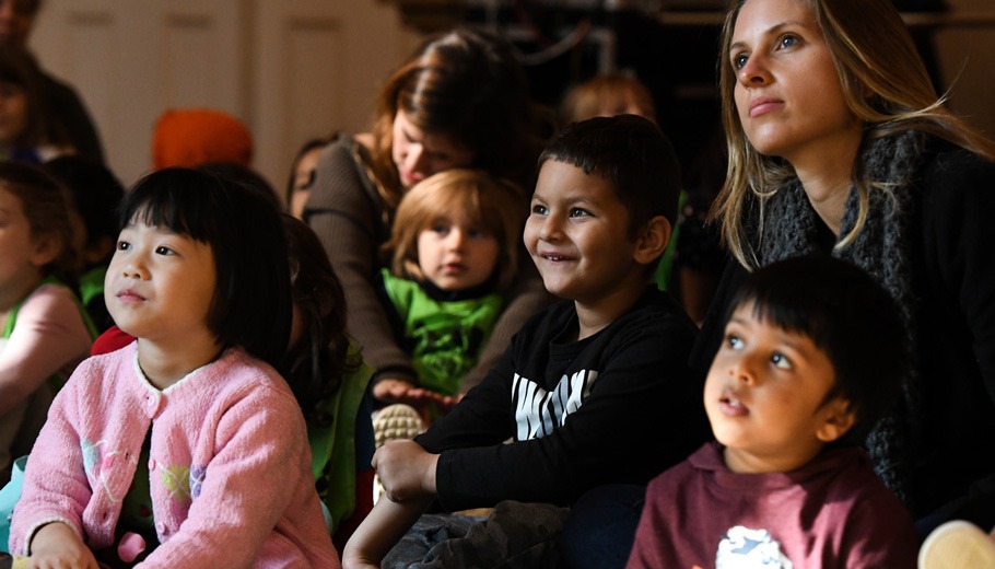 children and parents watching a performance