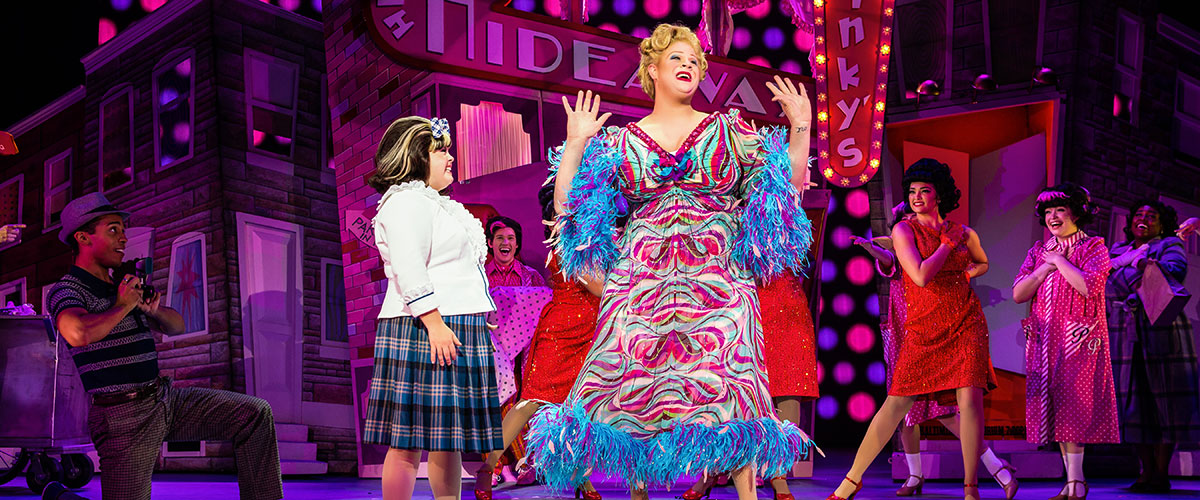     “Welcome to the 60s” - (from L) Niki Metcalf as “Tracy Turnblad,” Andrew Levitt (aka Nina West) as “Edna Turnblad” and company in Hairspray.  Photo: Jeremy Daniel. 